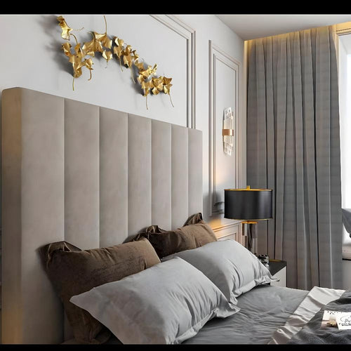 Modern bedroom with double bed headboard, pillows, golden leaf decoration, and gray curtains.