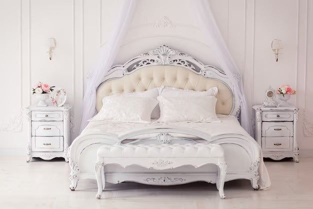 Elegant Emperor Bed Size UK with ornate headboard, bedside tables, and a sheer canopy.