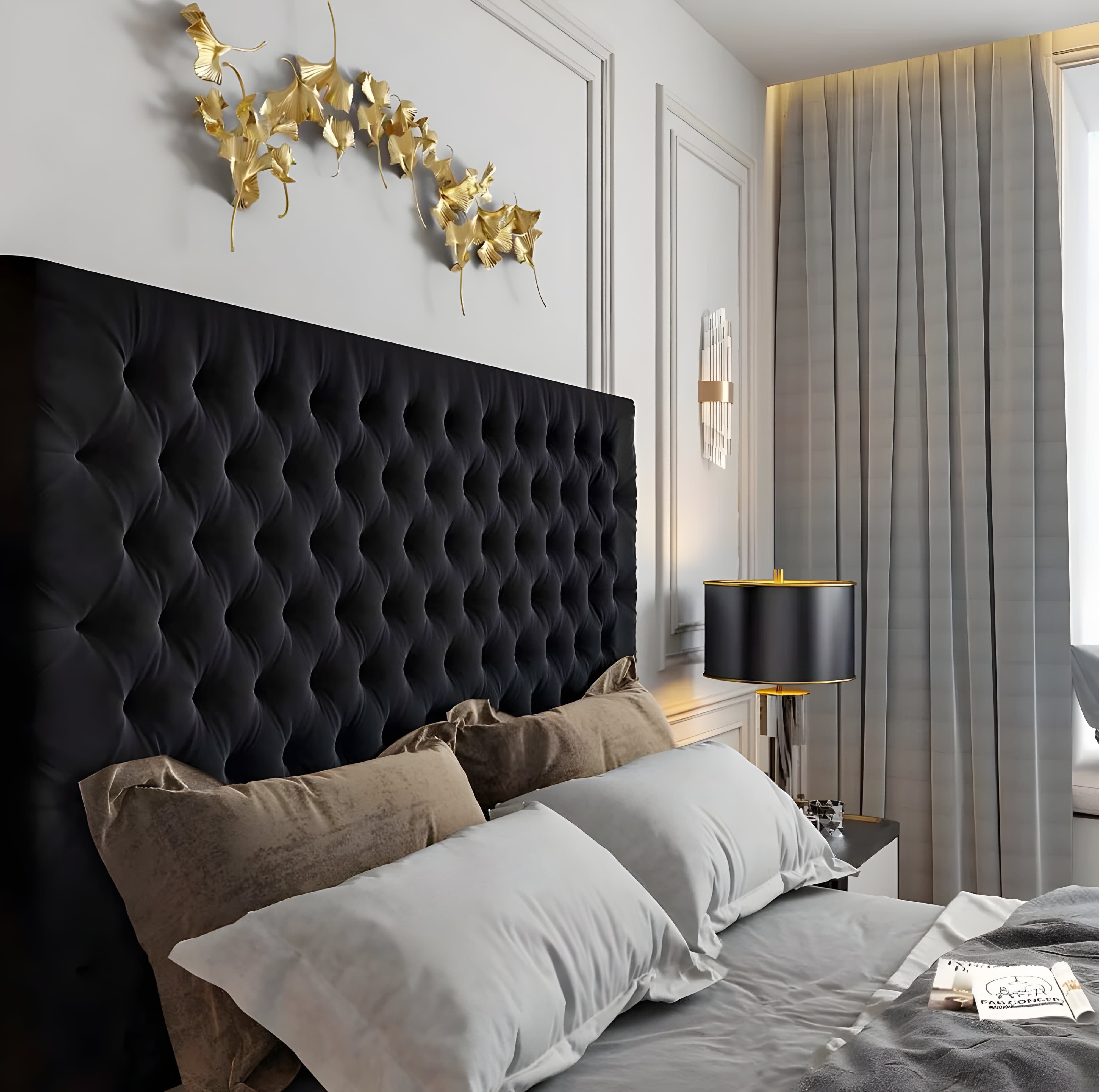 Luxurious bedroom with a tufted black king-size headboard and golden decorative wall art.
