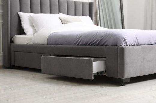 King-size bed with gray upholstery and a storage drawer underneath.