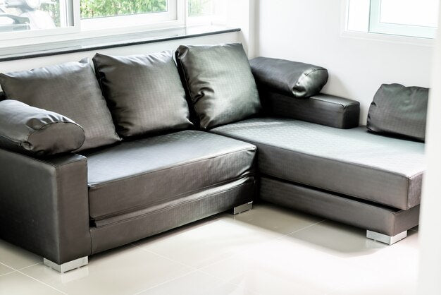 Modern sofa bed in a bright room with large cushions.