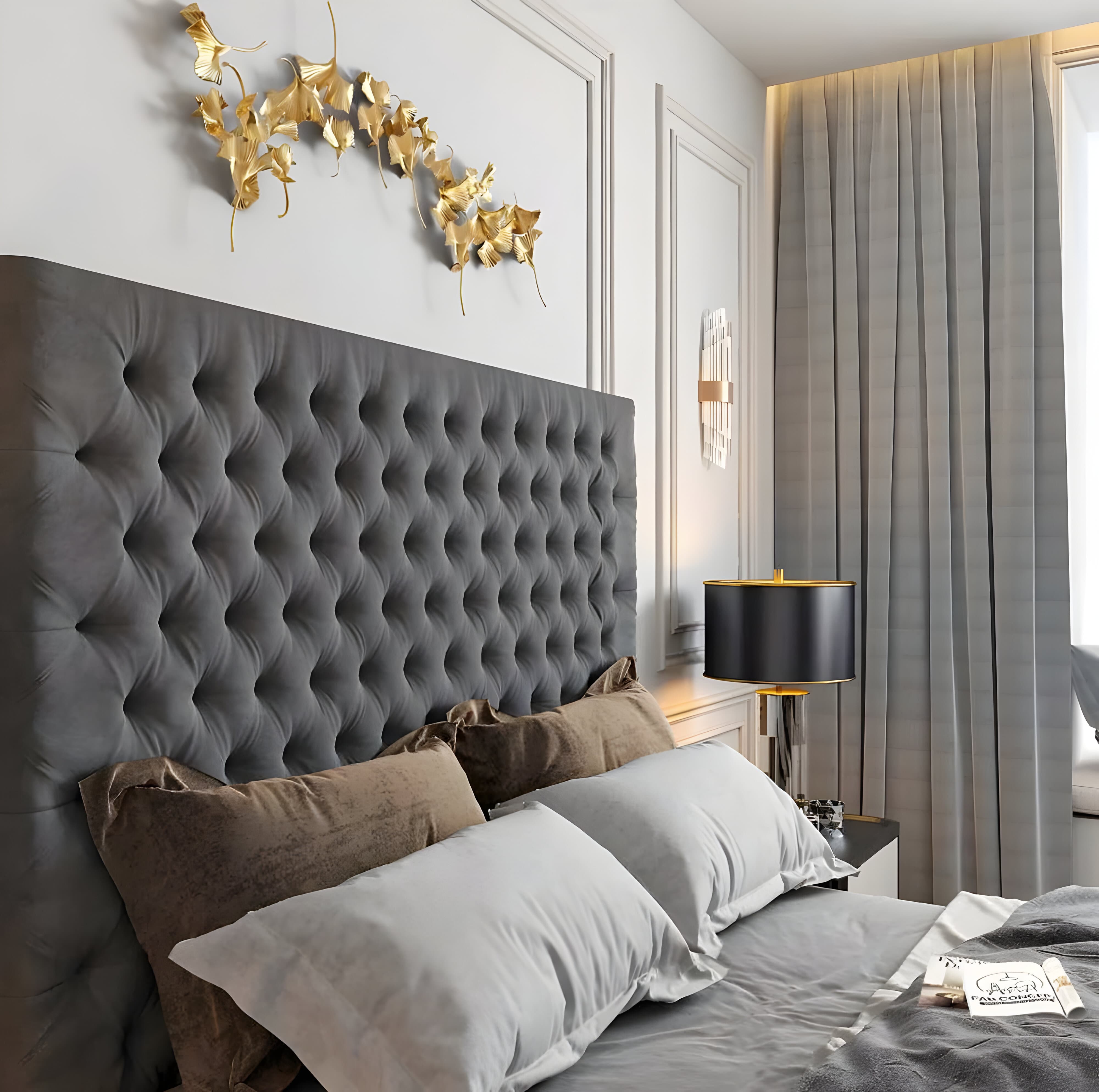 Stylish bedroom with a single bed headboard, decorative golden wall art, and a black and gold lamp.