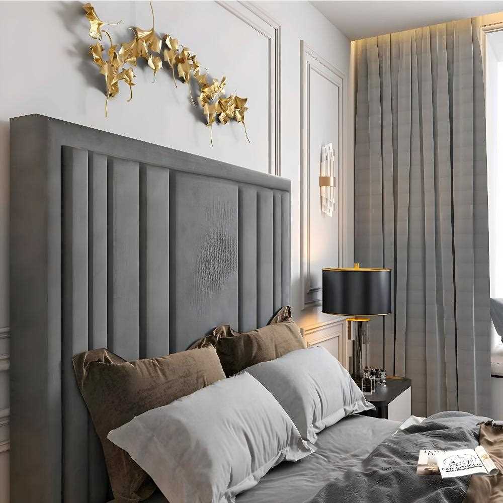 Modern bedroom with gray Alexander tv bed, gold wall art, and black lamp.