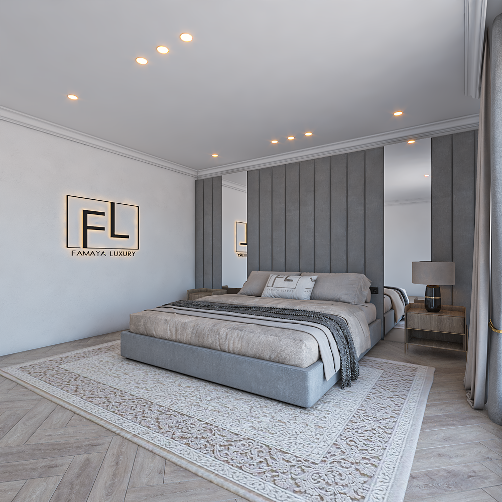 A bedroom with a large bed, grey Amaya wall panel bed frame, a patterned rug, and a nightstand with a lamp.
