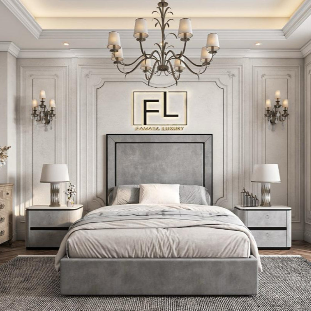 A luxurious bedroom featuring a gray, piped bed frame—The Lapita piped bed frame—flanked by bedside tables and a chandelier overhead.
