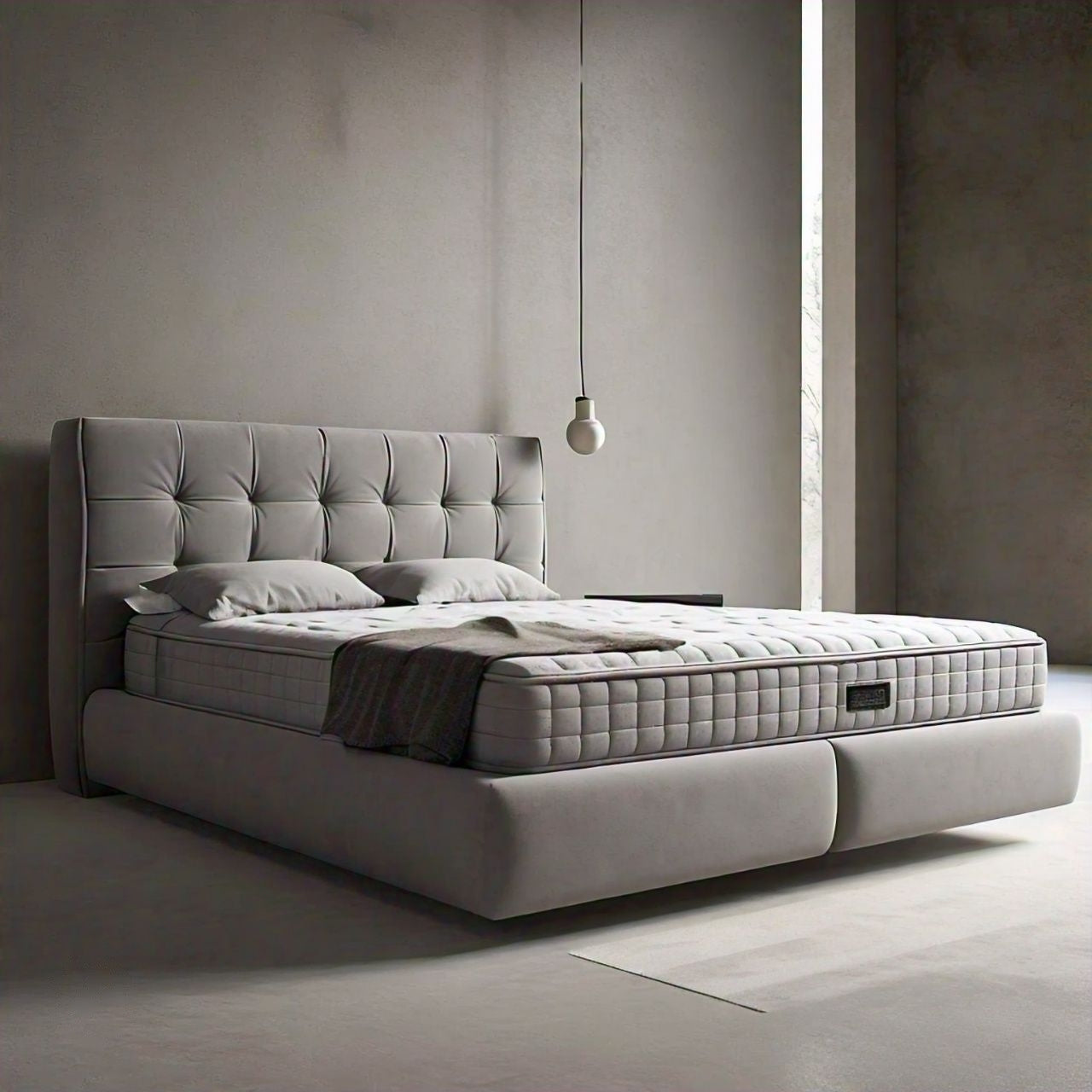 Small double bed with mattress a tufted gray headboard in a minimalist room.