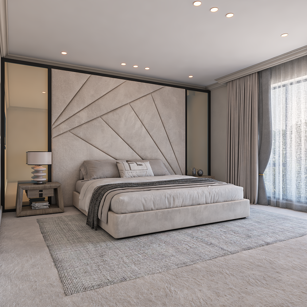 Modern bedroom with a large beige bed against a geometric wall. Soft lighting, gray rug, bedside table with a lamp, and sheer curtains on the window.